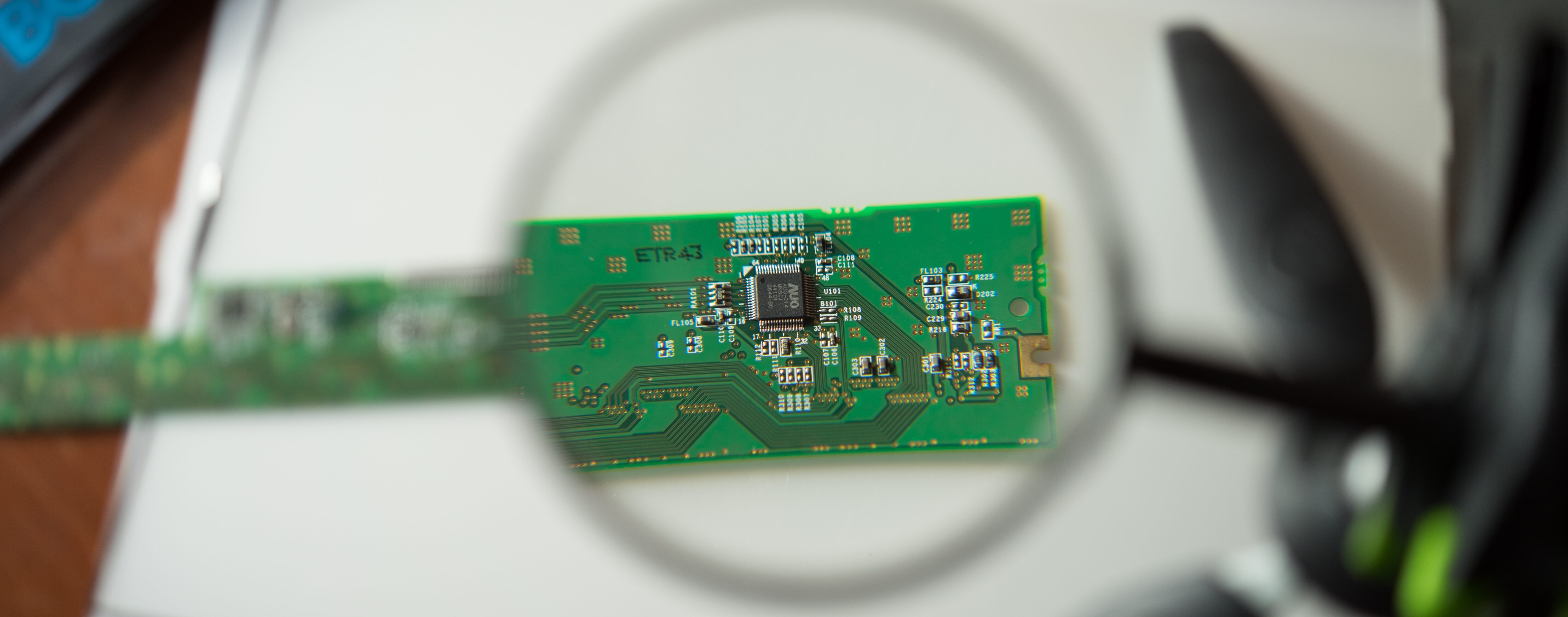 Engineer Looking Circuit Board Through Magnifying Glass 1